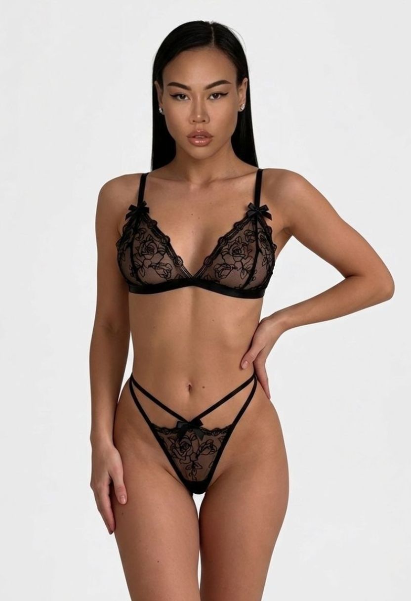 Cleo black rose lace bralette and strappy V-string panty set on model, front view