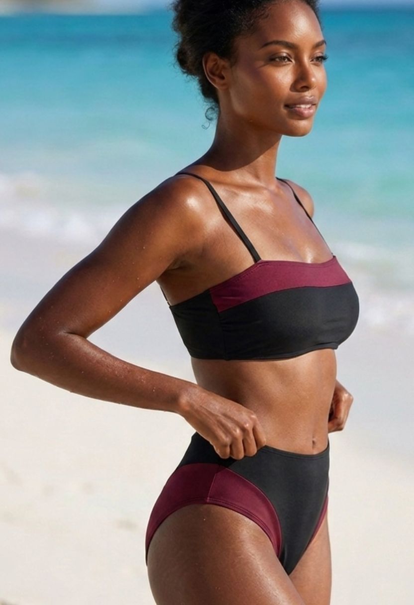 Sorelle black bandeau bikini top with burgundy contrast on model, side view