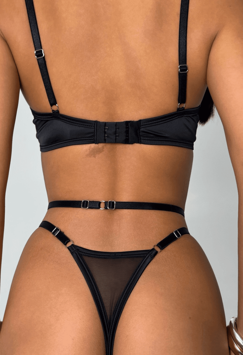 Stella nude bra and thong with black satin straps on model, close-up back view