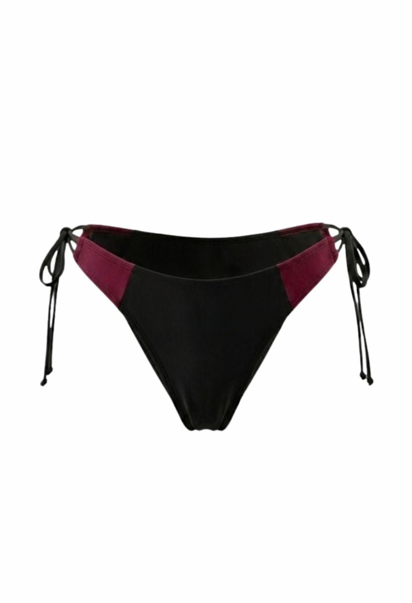Vera black cheeky bikini bottom with burgundy contrast hip panels, flat lay