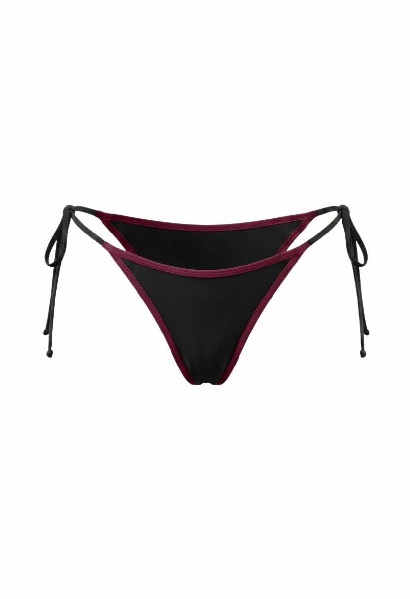 Vita black tie-side bikini bottom with burgundy trim, flat lay