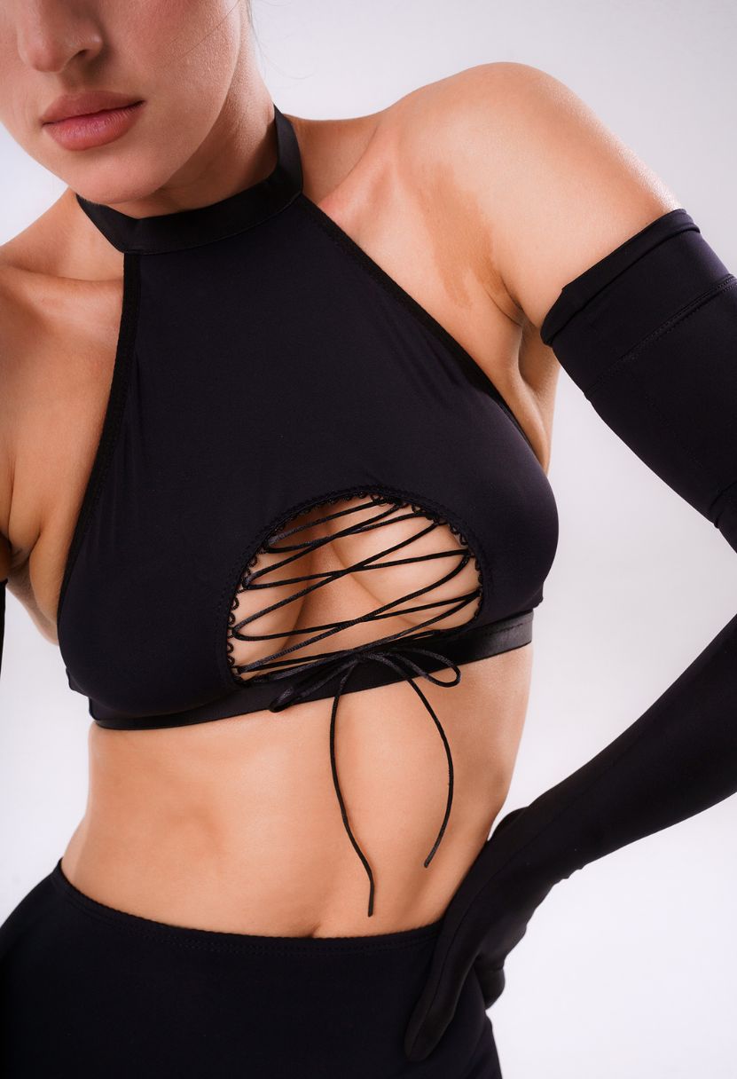 Zoe black gloves on model, angled close-up with lace-up halter bra